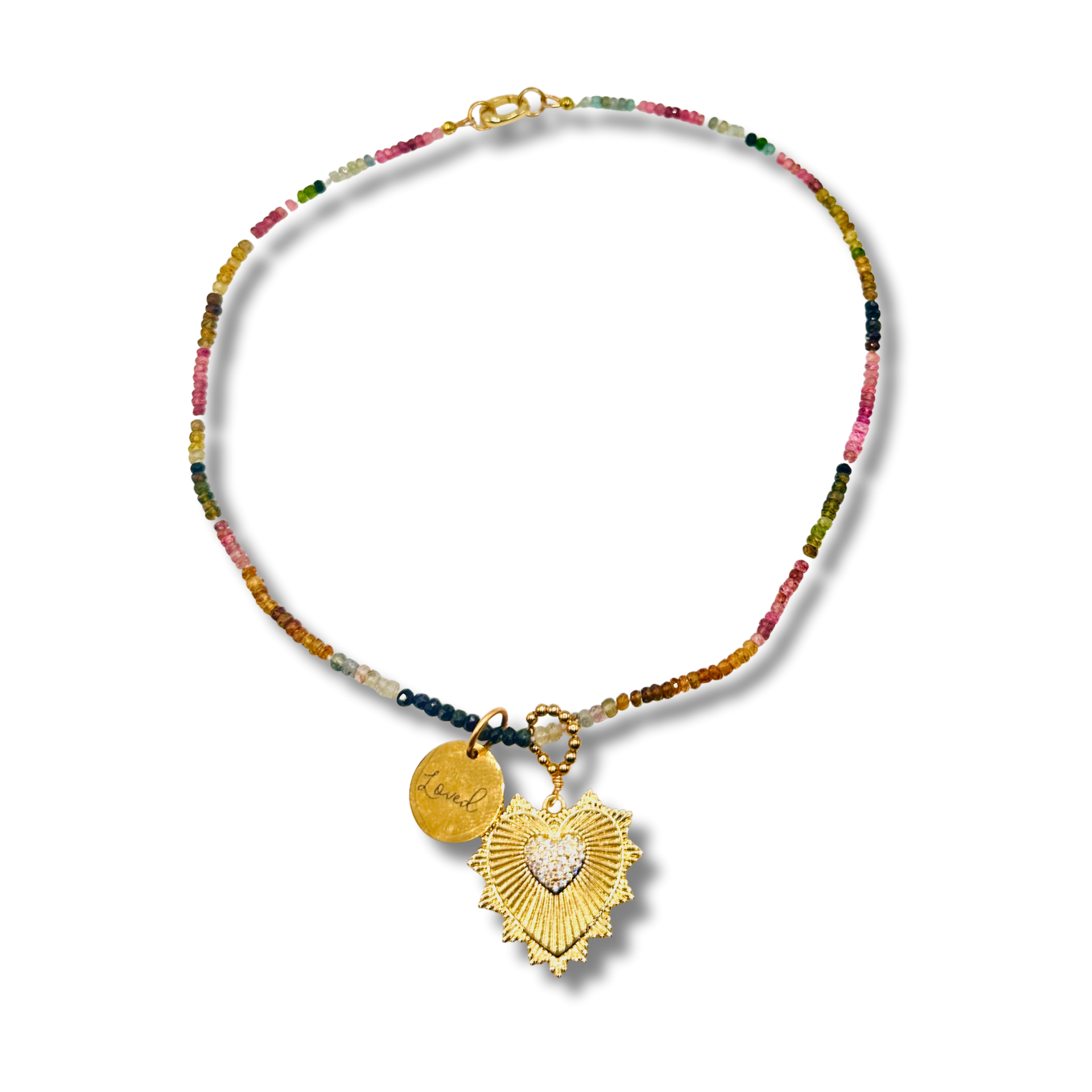 Necklace with colorful beads and gold heart pendant on a white background