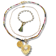 Set of necklaces with colorful beads and gold pendants on a white background
