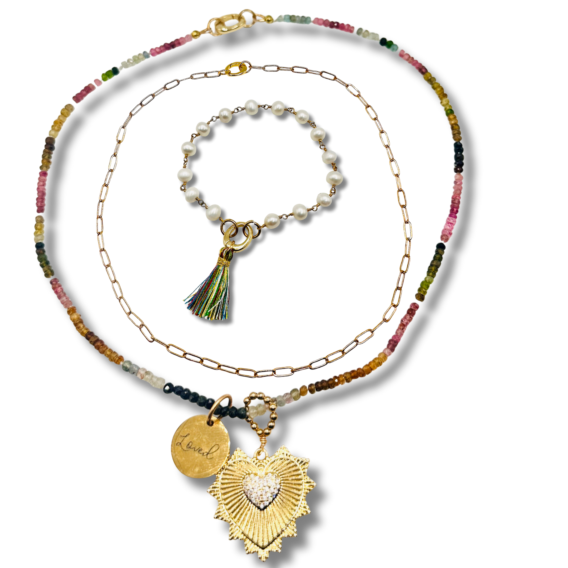 Set of necklaces with colorful beads and gold pendants on a white background