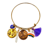 Gold bracelet with various charms on a white background