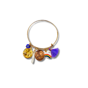Gold bangle with various charms on a white background