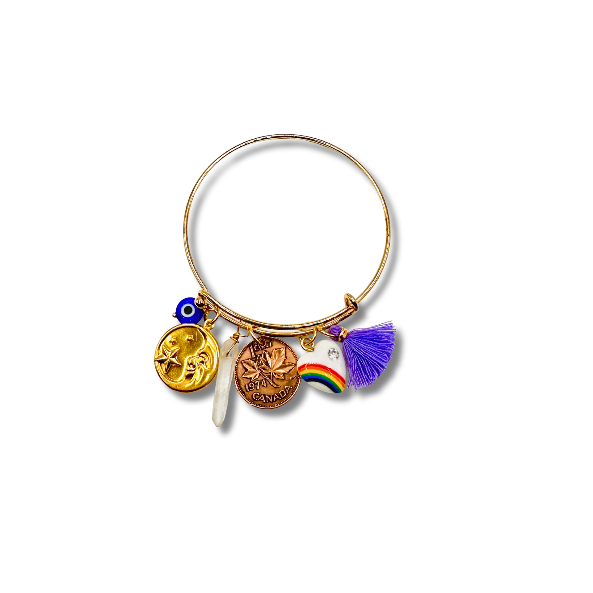 Gold bangle with various charms on a white background