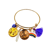 Gold bracelet with various charms on a white background