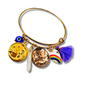Gold bangle with various charms including a coin, tassel, and rainbow design on a white background