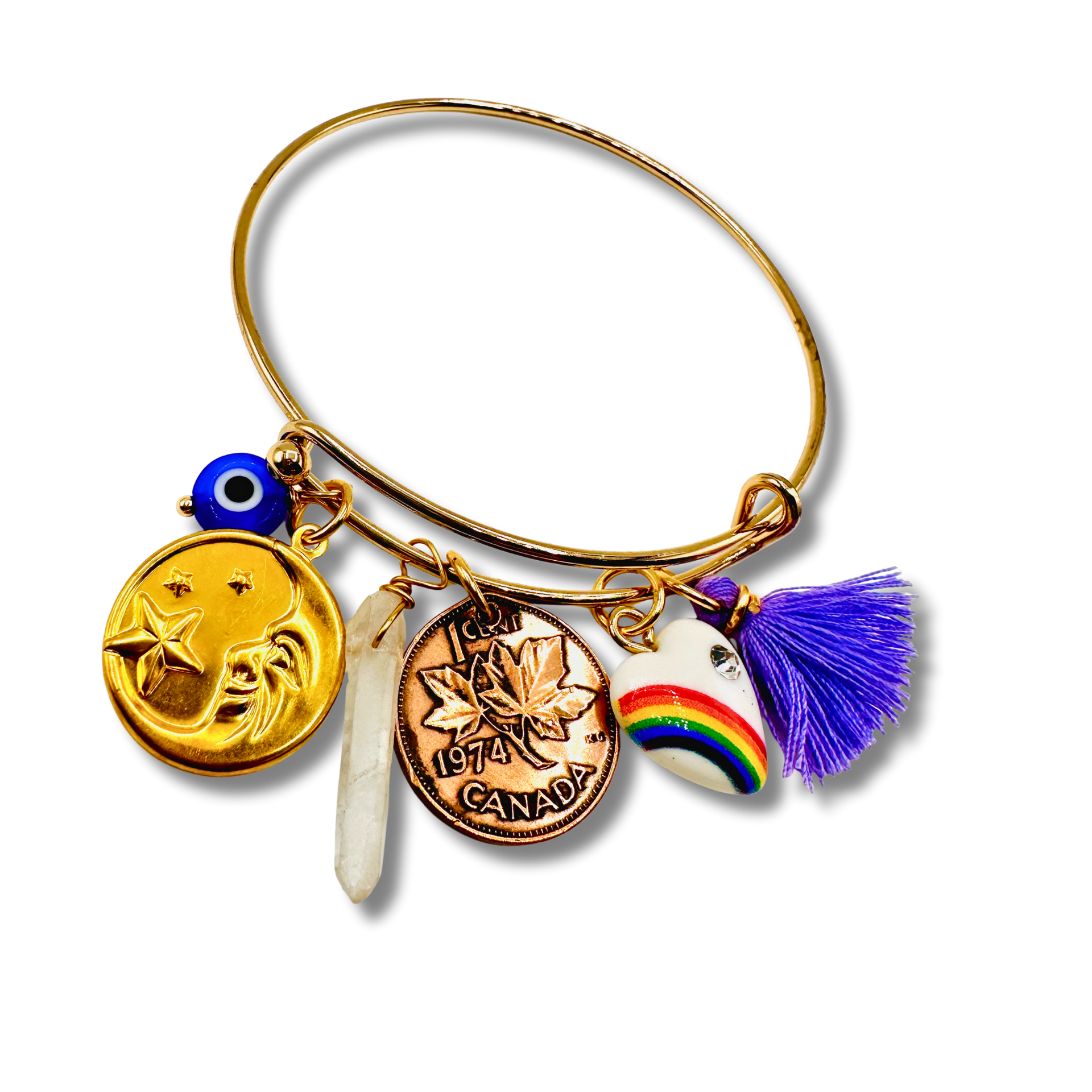 Gold bangle with various charms including a coin, tassel, and rainbow design on a white background
