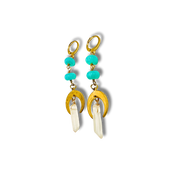Gold earrings with turquoise beads and white stones on a white background