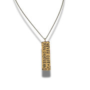 Gold pendant necklace with engraved text on a white background