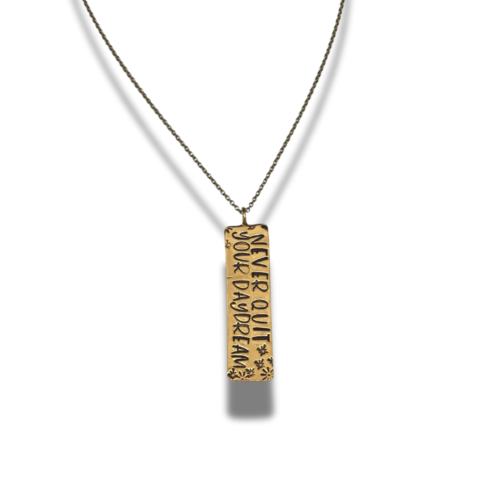 Gold pendant necklace with engraved text on a white background