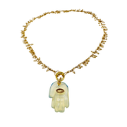 Necklace with a hamsa hand pendant on a white background
