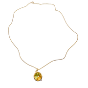 Gold necklace with a yellow gemstone pendant on a white background locket