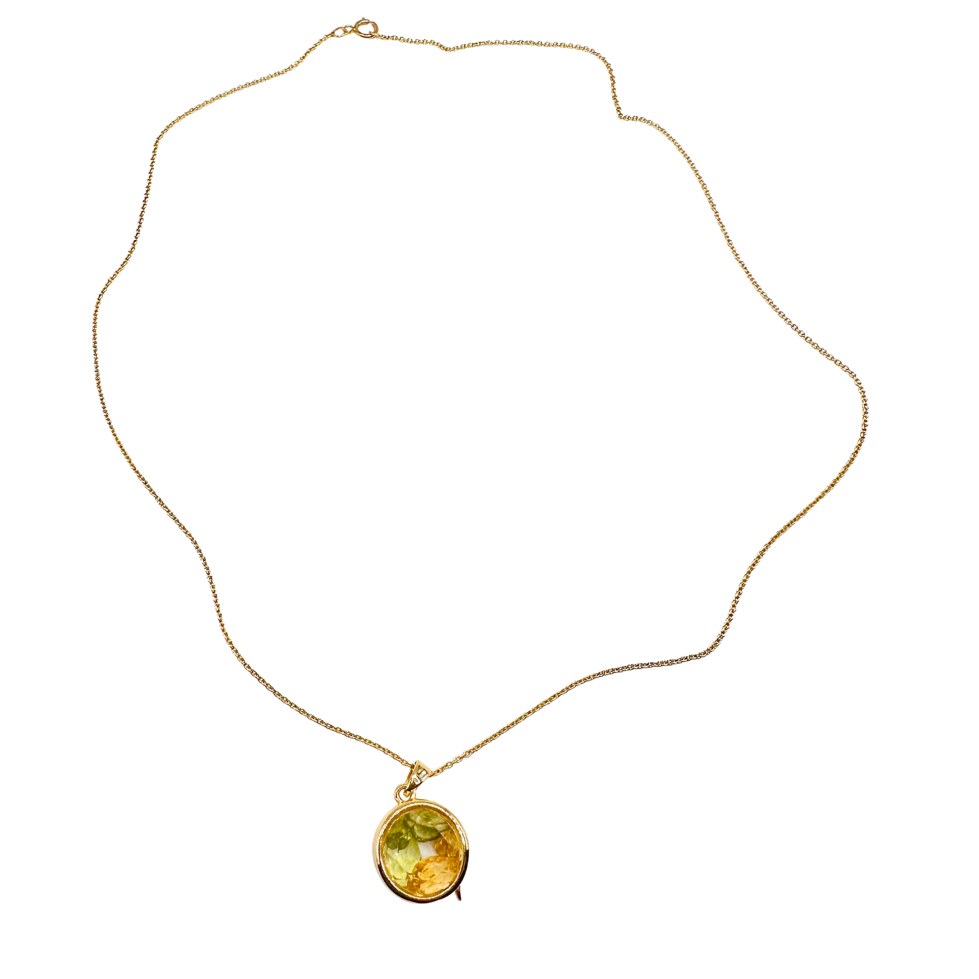 Gold necklace with a yellow gemstone pendant on a white background locket
