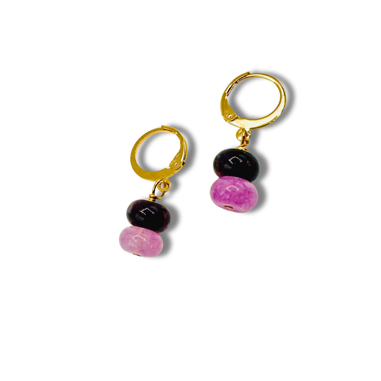 Pair of hoop earrings with black and pink beads on a white background