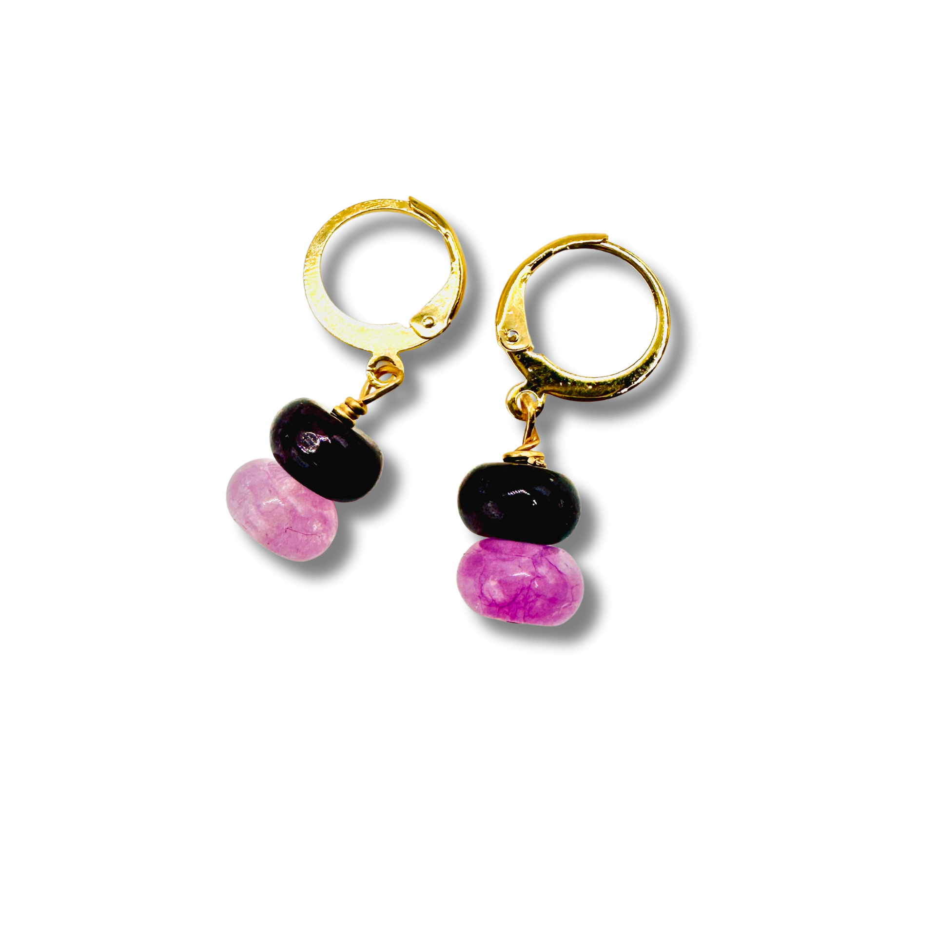 Pair of gold hoop earrings with black and pink beads on a white background