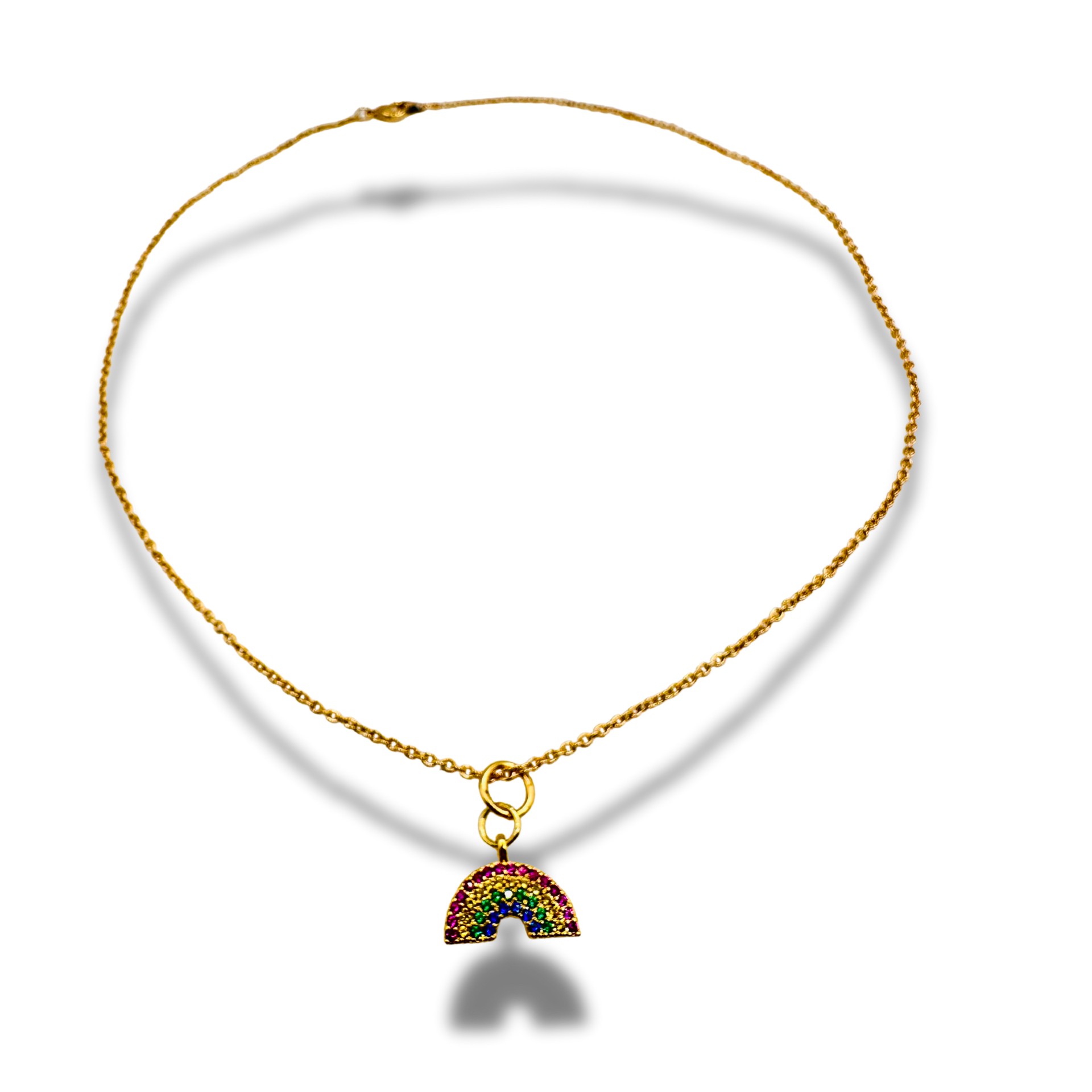 Gold necklace with a rainbow charm on a white background