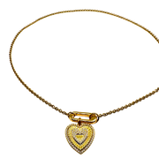 Gold necklace with a heart-shaped pendant on a white background