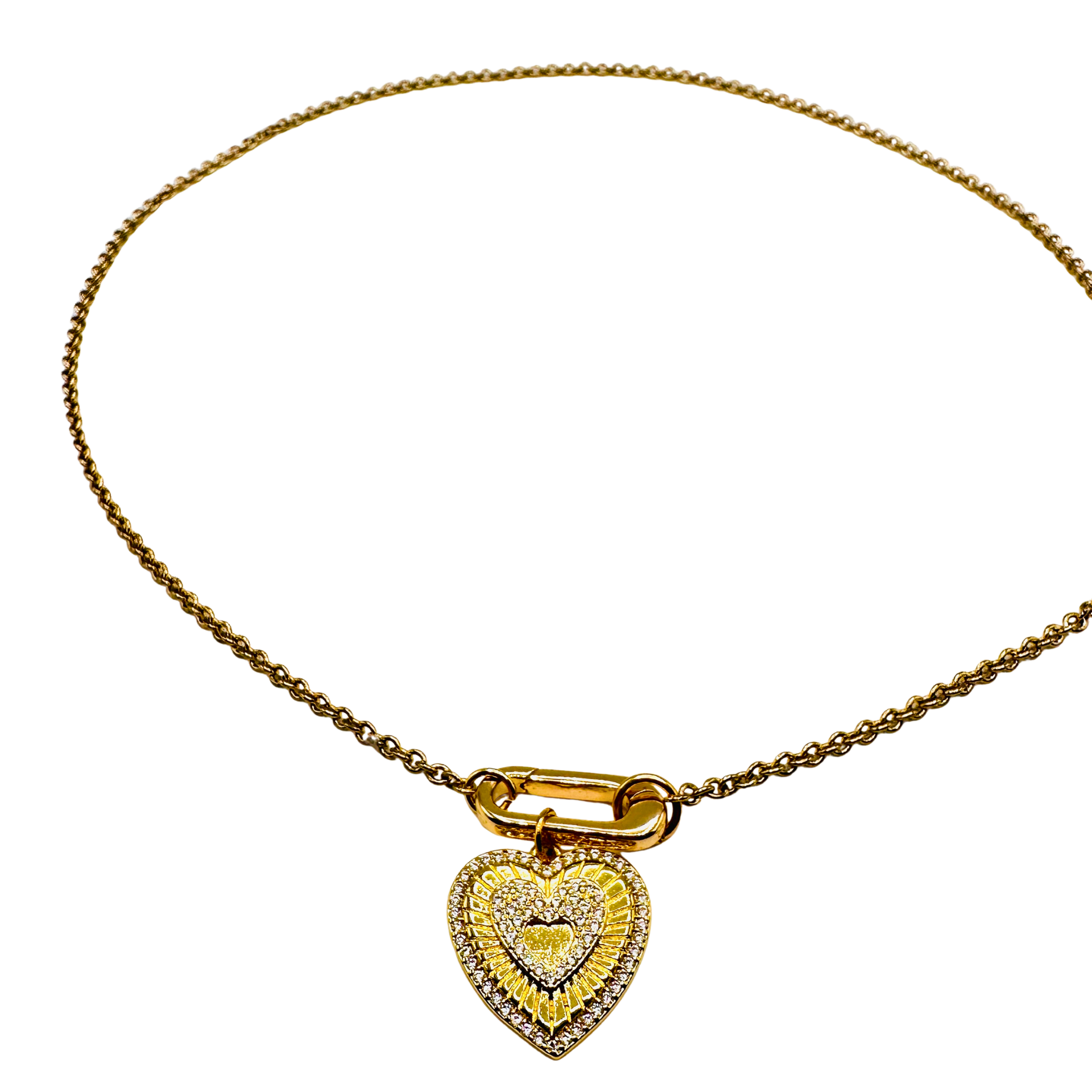 Gold necklace with a heart-shaped pendant on a white background