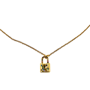Gold lock-shaped pendant necklace with colorful stones on a white background