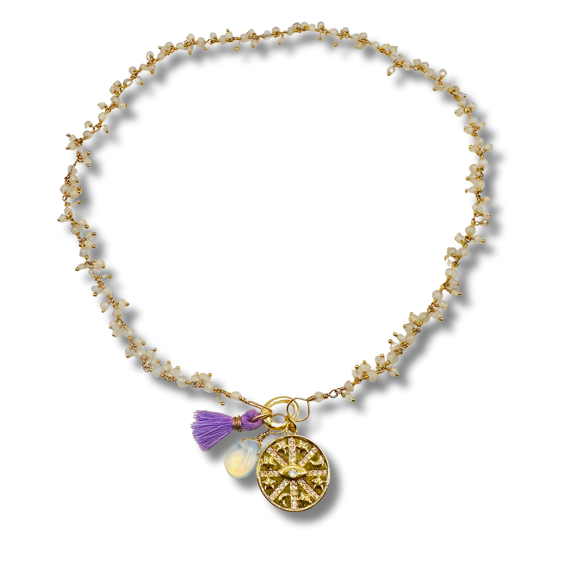 Gold anklet with charms on a white background