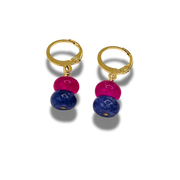 Gold hoop earrings with pink and blue beads on a white background