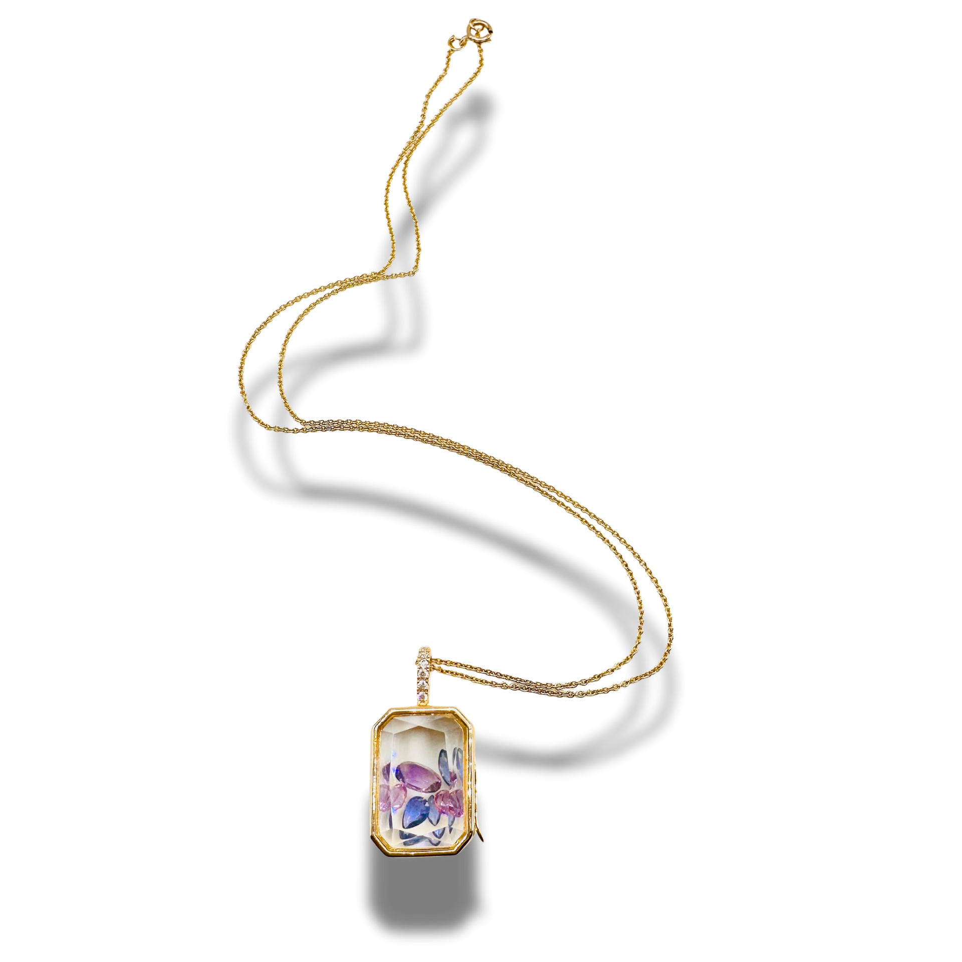 Gold necklace with a rectangular pendant on a white background