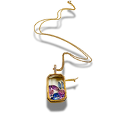 Gold necklace with a colorful pendant on a white background