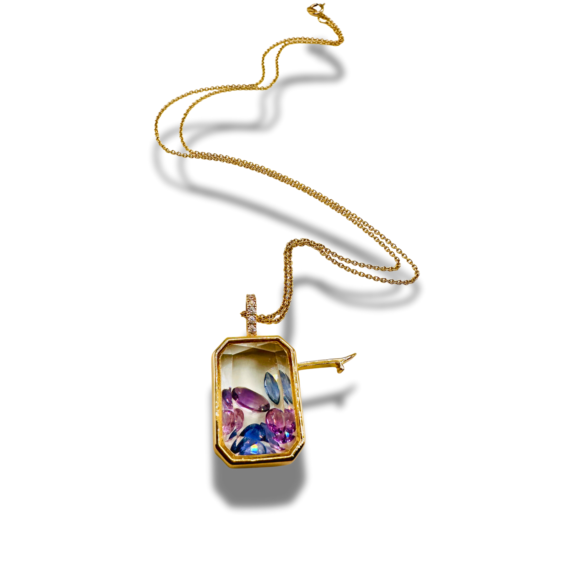 Gold necklace with a colorful pendant on a white background