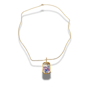 Gold necklace with a rectangular pendant on a white background