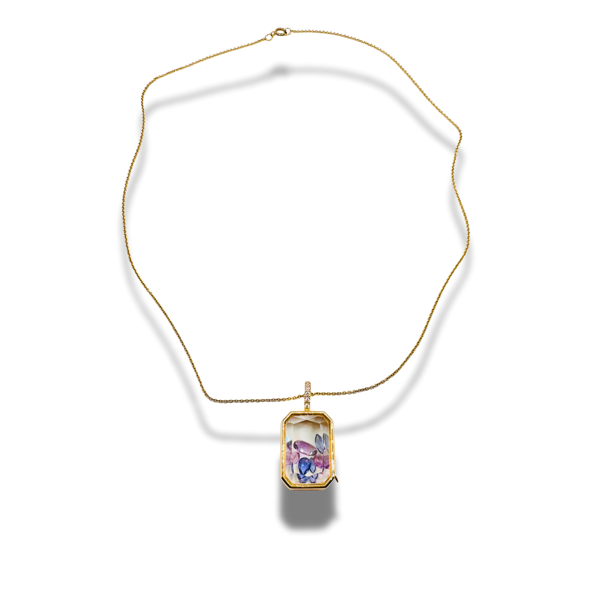Gold necklace with a rectangular pendant on a white background