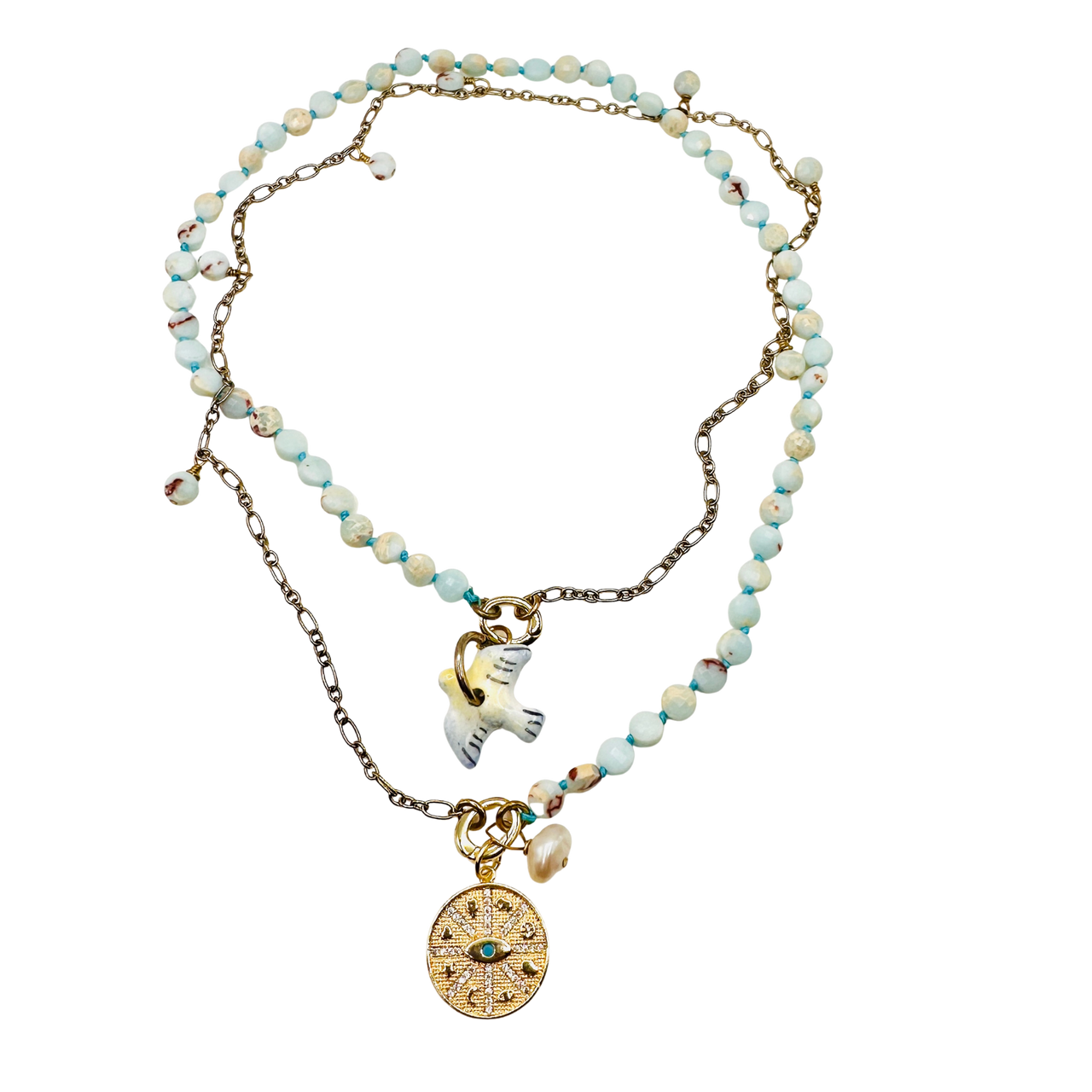 Necklace with beaded chain and gold charm on a white background