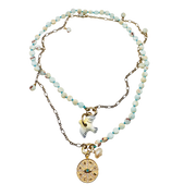 Necklace with beaded chain and gold charm on a white background