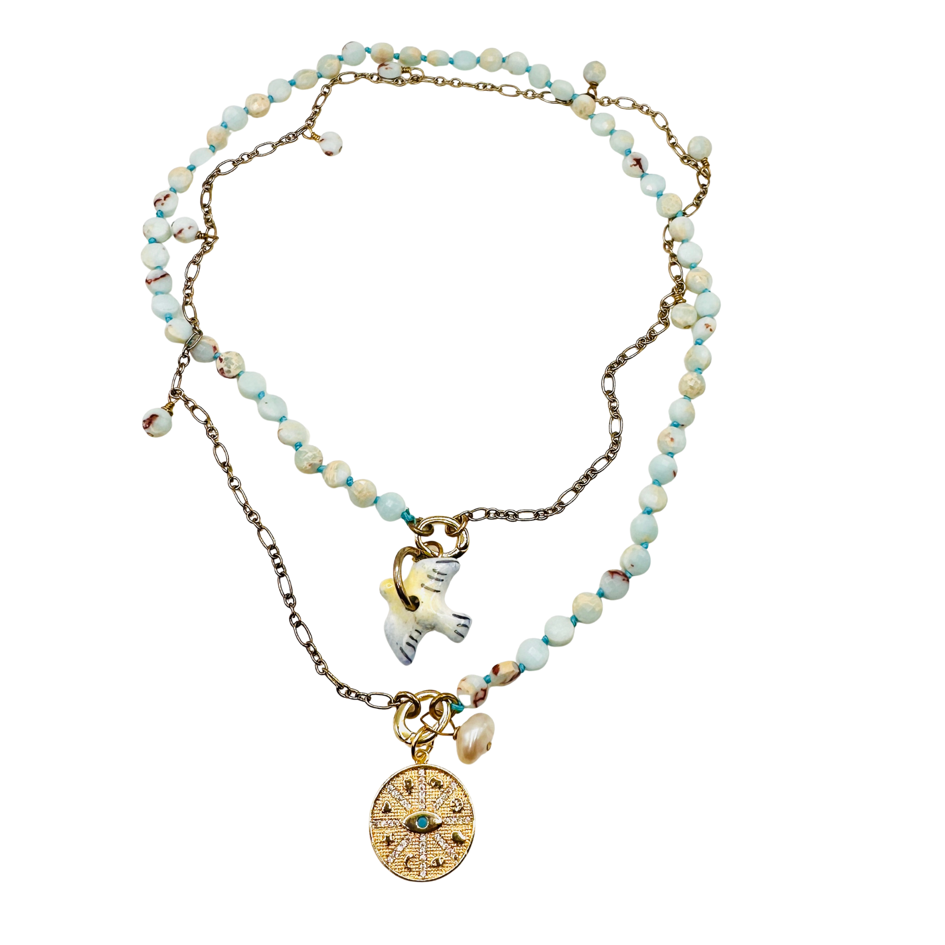 Necklace with beaded chain and gold charm on a white background
