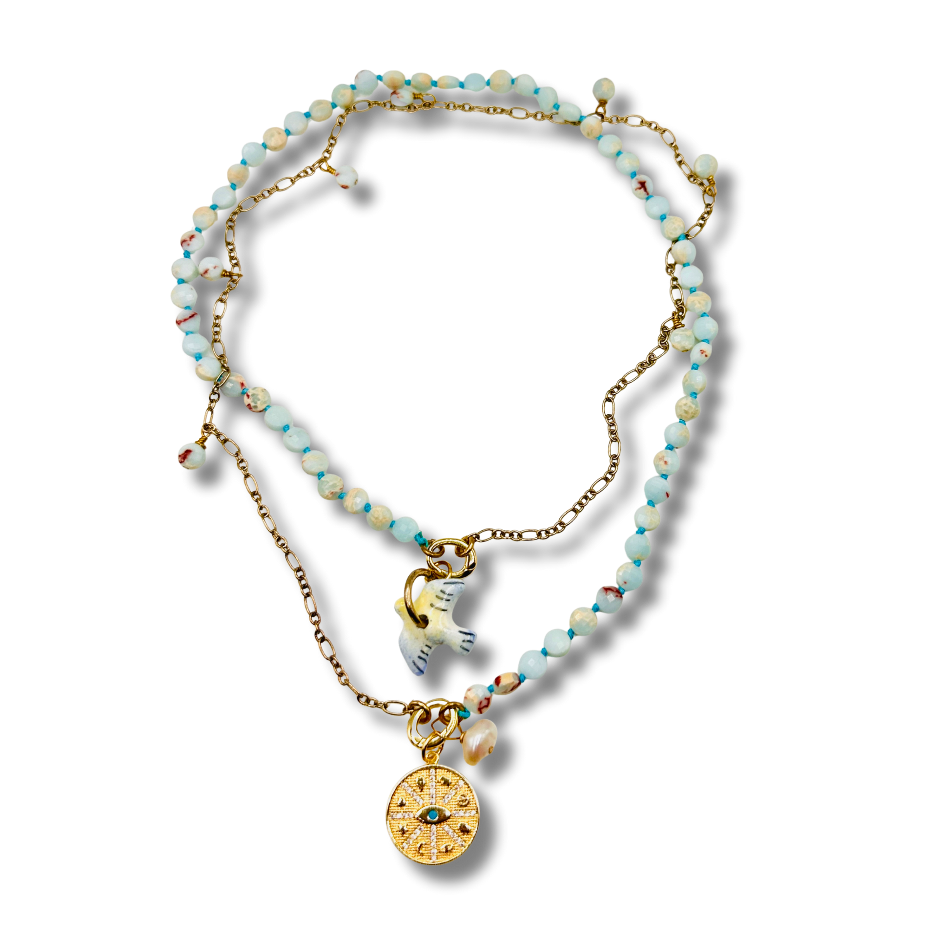 Necklace with beaded chain and gold pendants on a white background