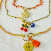 Two necklaces with charms on a white background