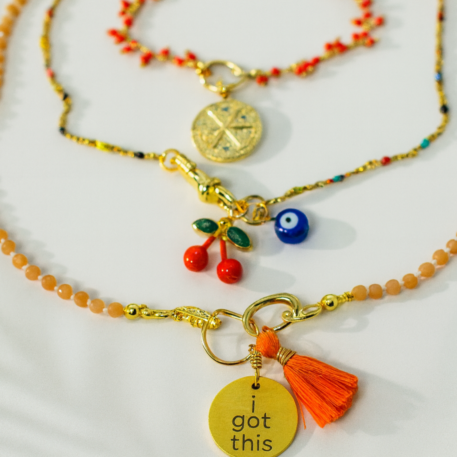 Two necklaces with charms on a white background