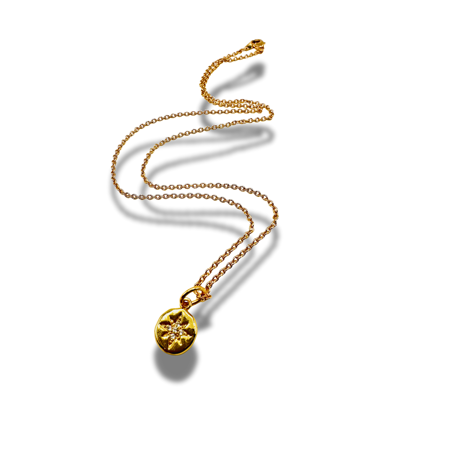 Gold necklace with a round pendant on a white background