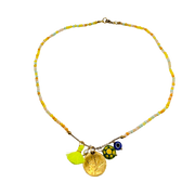 Necklace with colorful beads and charms on a white background