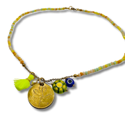 Necklace with colorful beads and charms on a white background