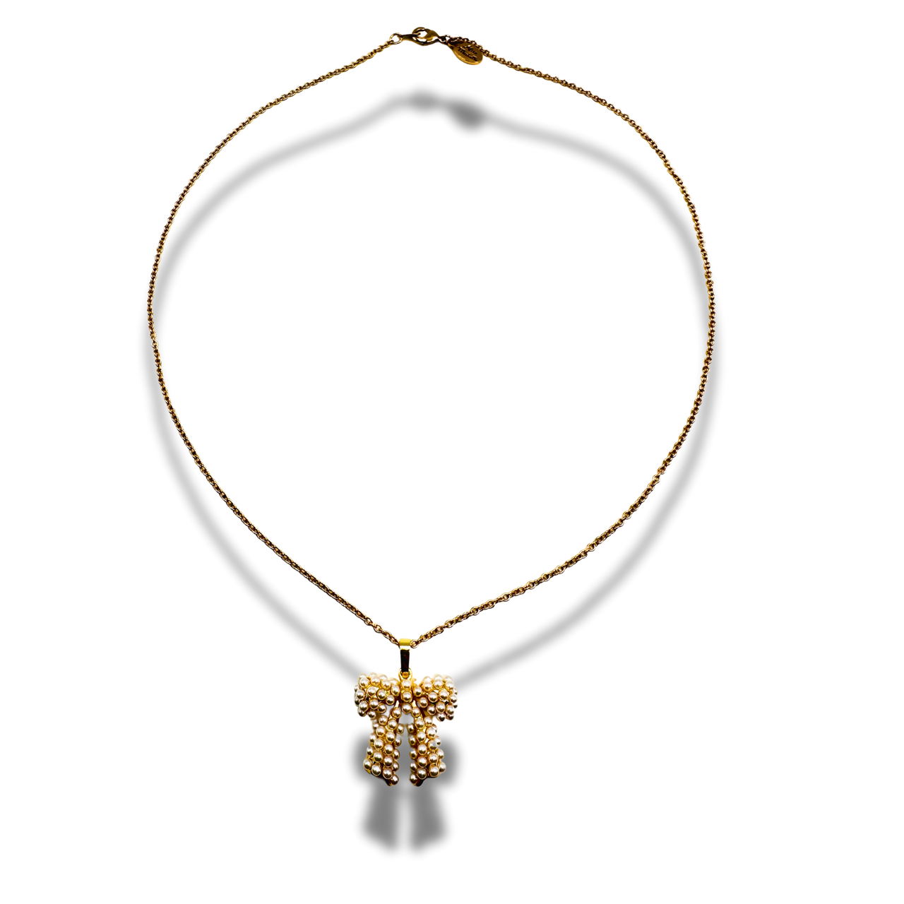 Gold necklace with a cross pendant on a white background