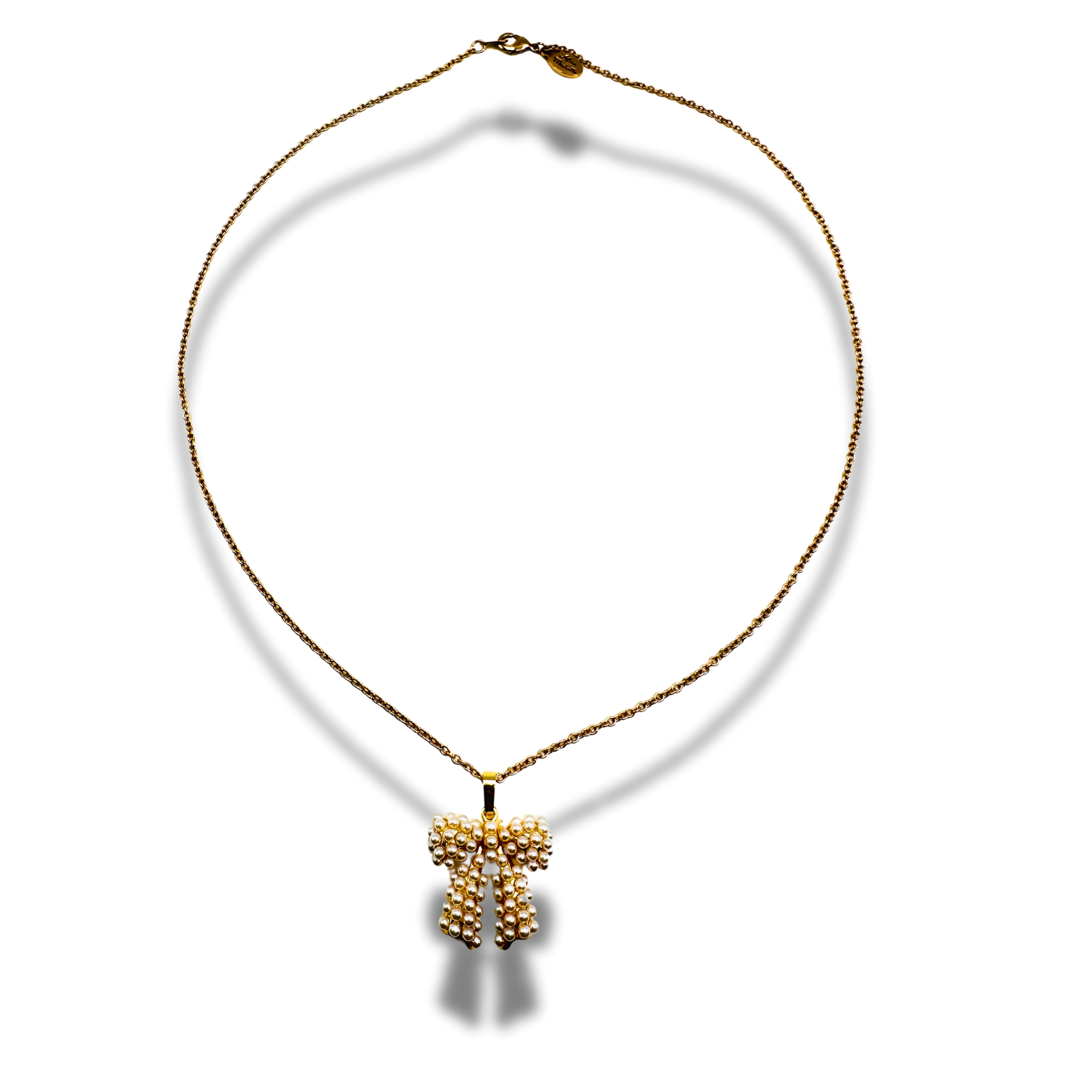 Gold necklace with a cross pendant on a white background