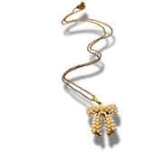 Gold necklace with a bow-shaped pendant on a white background