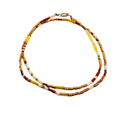 Necklace with multicolored beads on a white background