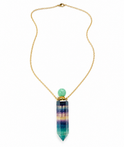 A gold chain necklace featuring a colorful striped crystal point pendant with a light green bead accent, shown against a plain white background.