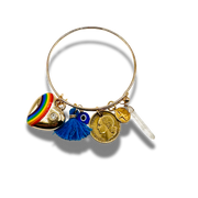 Gold bracelet with various charms on a white background