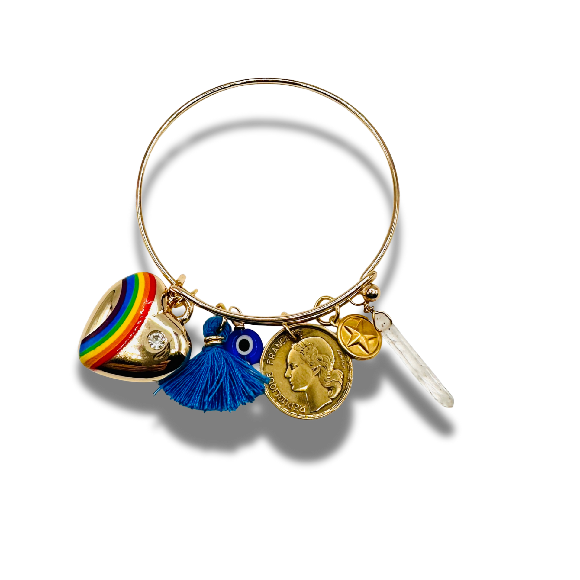 Gold bracelet with various charms on a white background