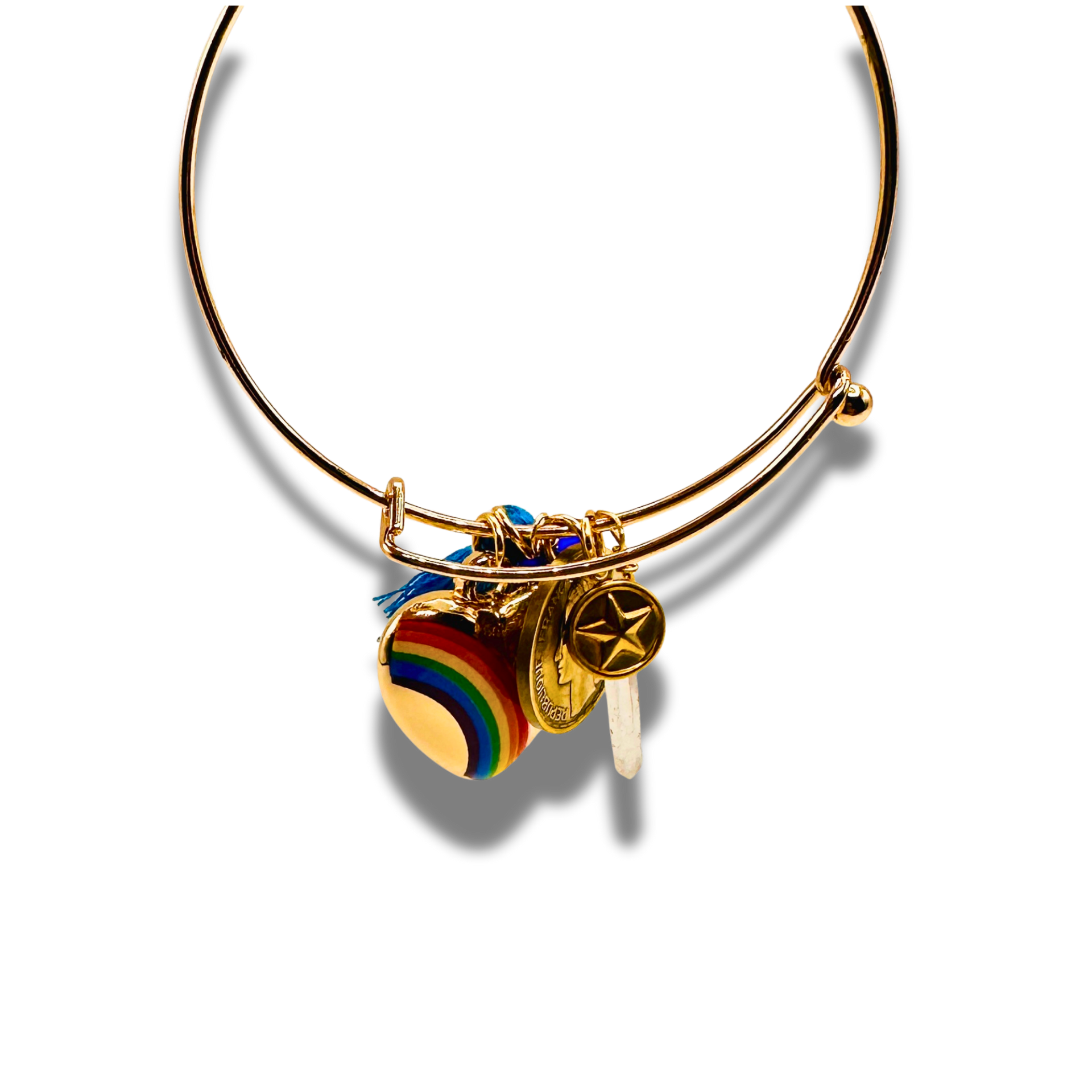 Gold bracelet with colorful heart charm on a white background