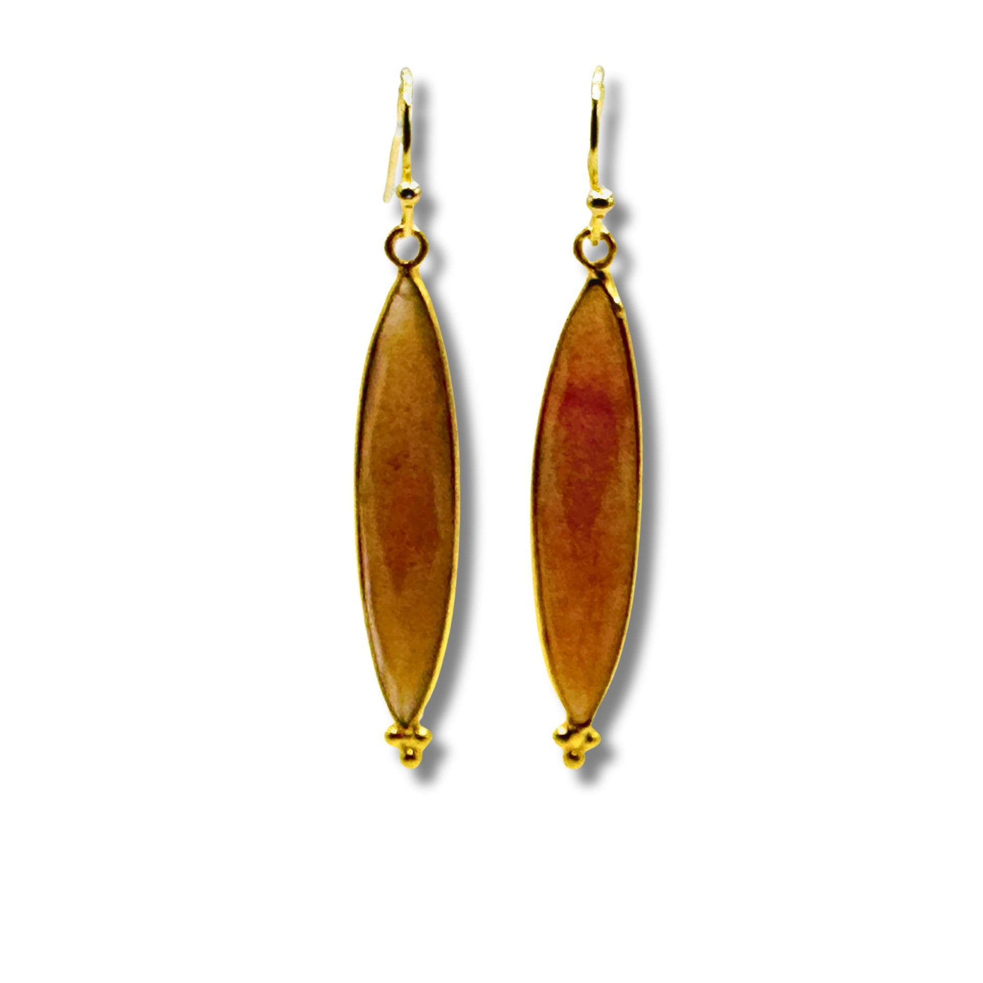 A pair of gold-plated brass bezel set dangle earrings with peach moonstone stones.