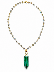 A beaded necklace featuring a large green malachite crystal pendant, suspended from a gold chain with small gray and iridescent beads, shown against a plain white background.