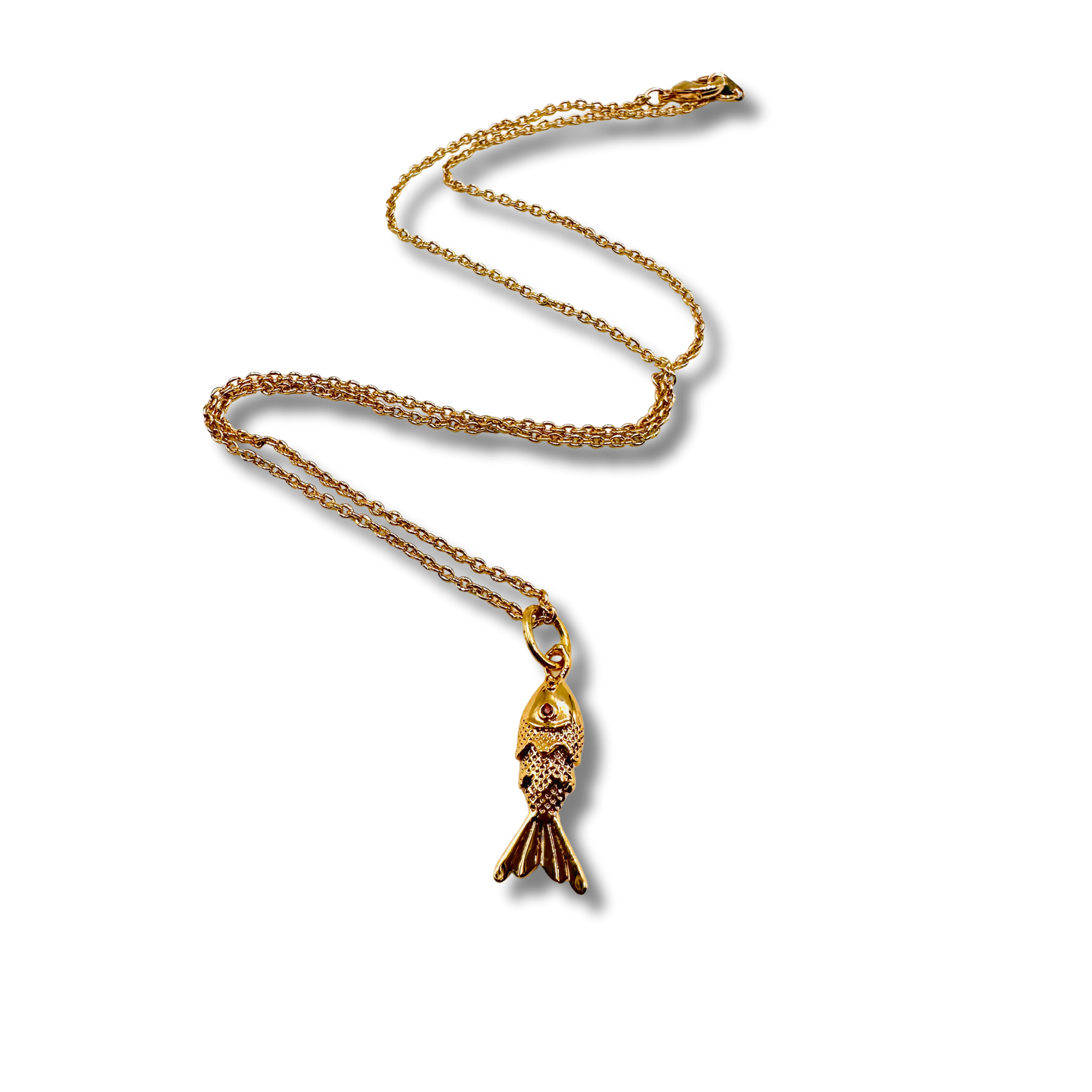 Gold necklace with a fish-shaped pendant on a white background
