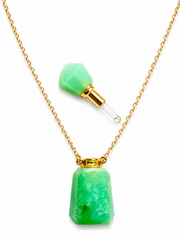 A gold chain necklace featuring a faceted green gemstone pendant and a matching small green gemstone dropper-style charm with a clear glass pipette tip, shown on a white background.