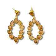 A pair of gold-plated brass bezel set cascading earrings with peach moonstone inlays.